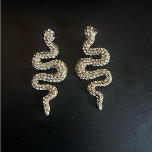 Gold toned snake earrings with rhinestones